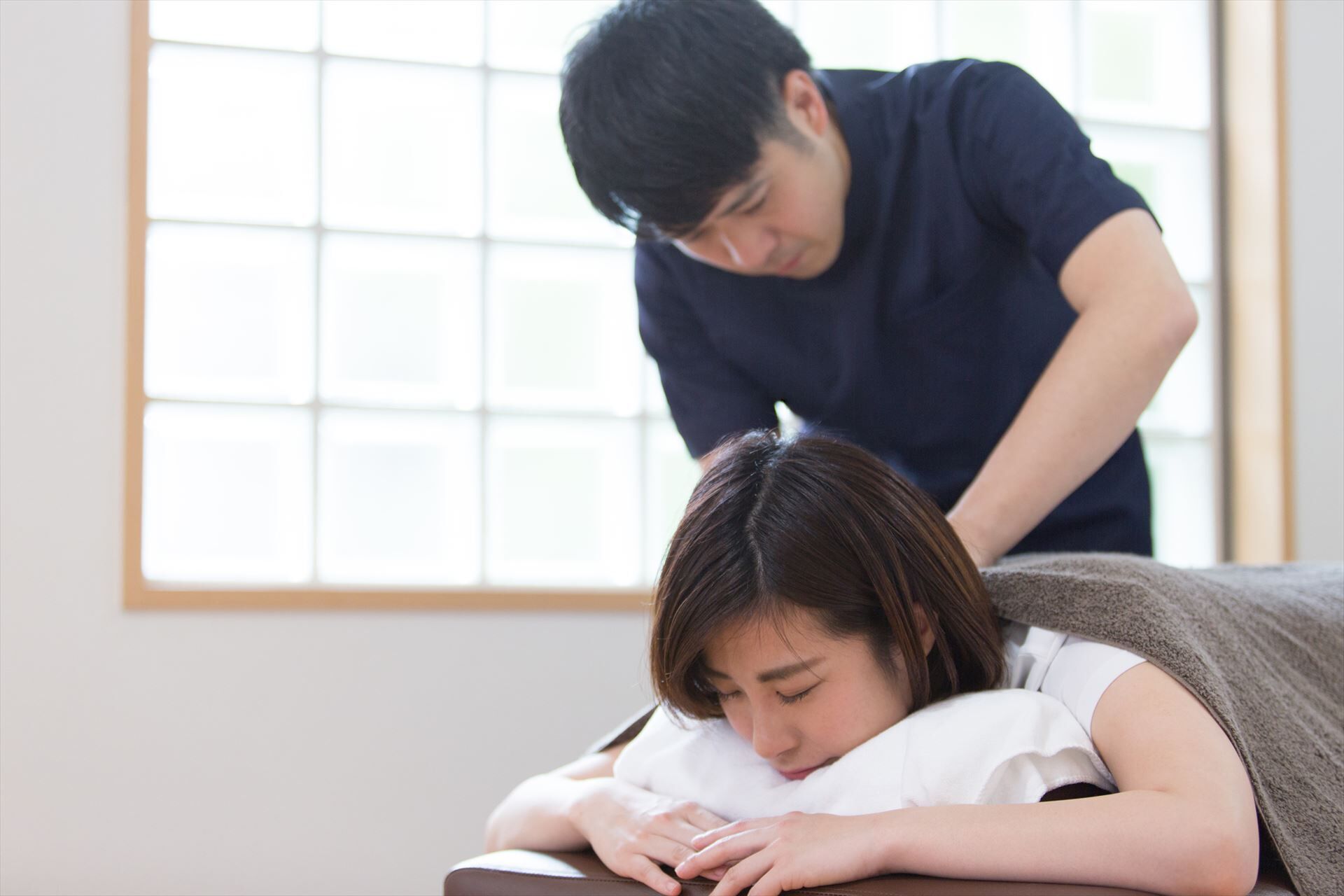 女性の方をもむスタッフ